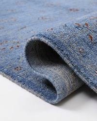 Close-up of cornflower blue over-dyed wool rug all-over floral pattern